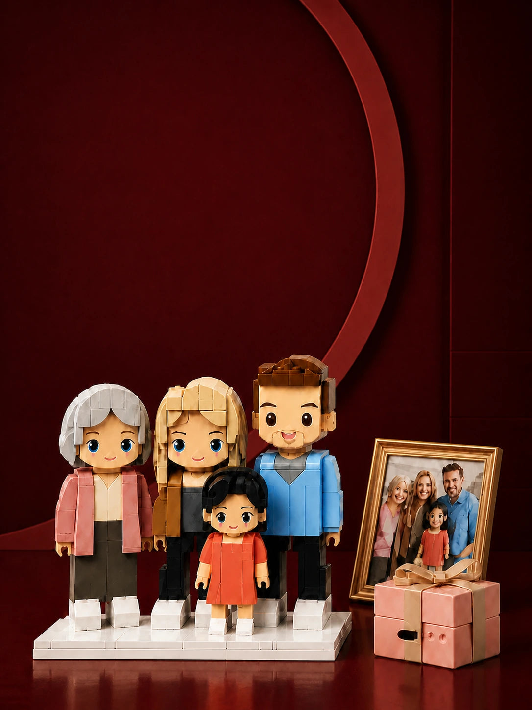 A bespoke brick-style family figure set displayed beside the family photograph and gift box